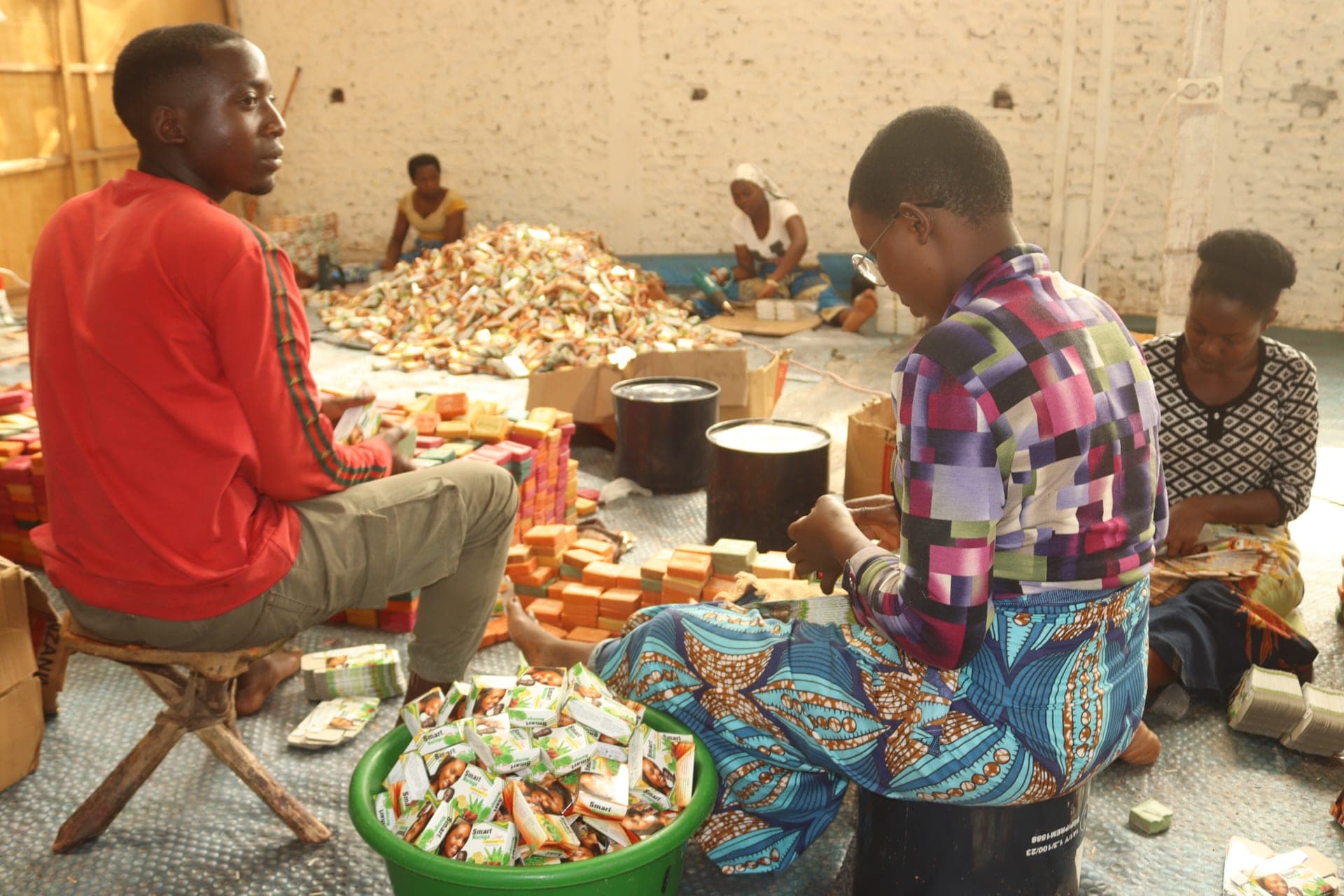 Young entrepreneurs packaging soap by hand in their workshop